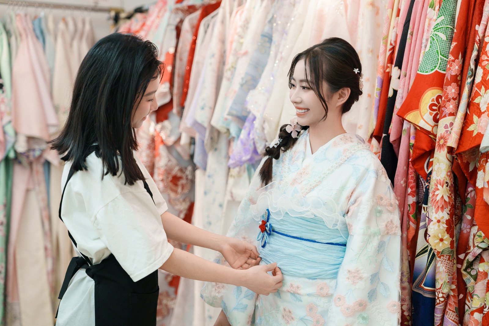Staff helping a guest into her kimono at LYAN